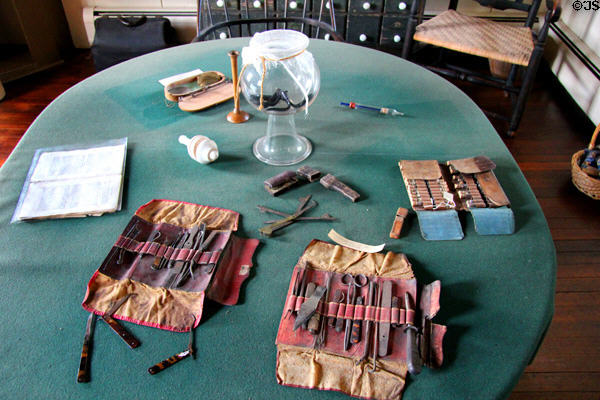 Table with early medical instruments & bowl of leeches at Dr. Hezekiah Chaffee House. Windsor, CT.