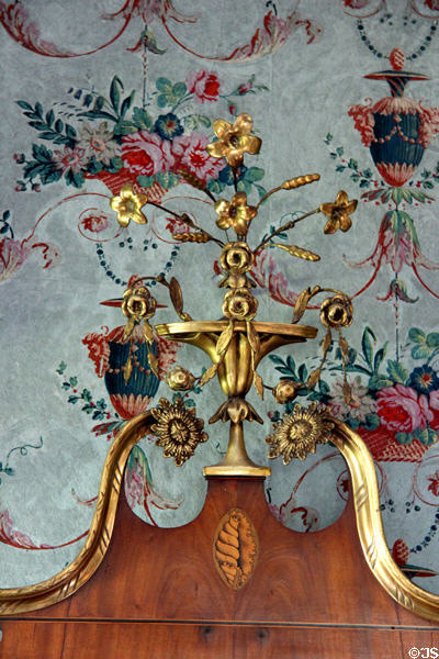 Flowered finial atop early American mirror with at Phelps-Hathaway House. Suffield, CT.