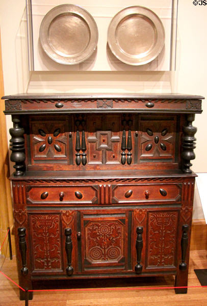 Cupboard (1675-90) attrib. to Peter Blin from Wethersfield, CT under pewter plates (c1695-1740) from Boston, MA at Yale University Art Gallery. New Haven, CT.