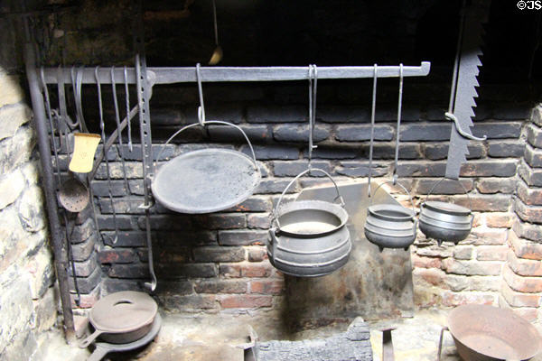 Fireplace andiron with pots at Old Stone House. Washington, DC.