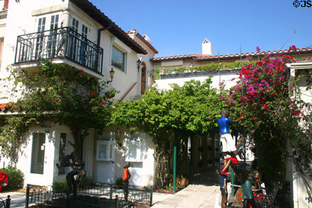 Flowered courtyard with sculptures on Worth Street. Palm Beach, FL.