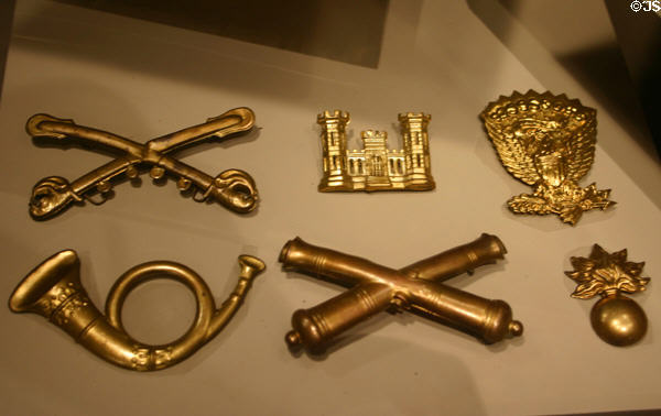 Civil War U.S. Army hat insignias (sabers of cavalry, castle of engineers, eagle of army, horn of infantry, cannons of artillery, flaming bomb of ordnance) at Atlanta Historical Museum. Atlanta, GA.
