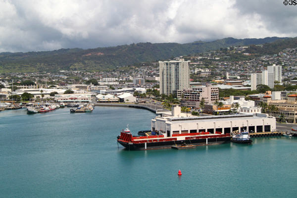 Honolulu harbor against Honolulu suburbs. Honolulu, HI.