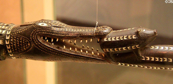 Detail of carved wood ceremonial staff (c1935) of crocodile eating a pig from Solomon Islands at Honolulu Academy of Arts. Honolulu, HI.