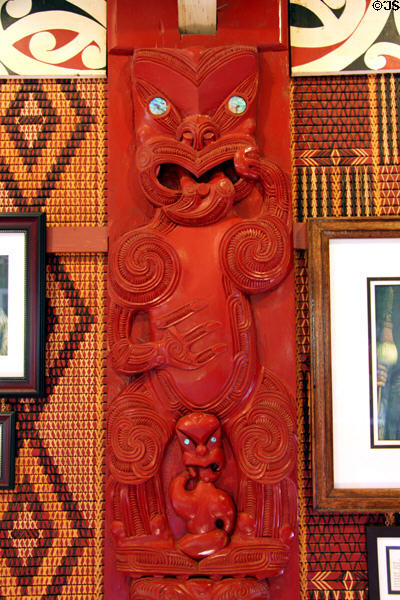 Aotearoa-Maori carved wooden plaque with Maori warrior sticking out tongue in defiance at Polynesian Cultural Center. Laie, HI.