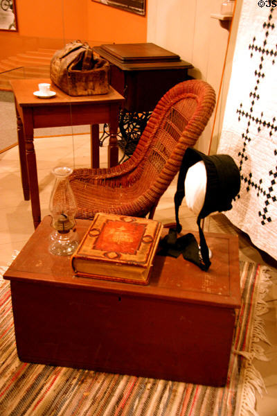 Wicker Rocker of Herbert Hoover's maternal grandmother with Quaker bonnet, meeting house oil lamp & bible. West Branch, IA.