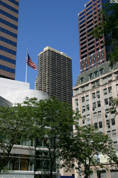 Black & white Huron Plaza (1983) (56 floors) (30 East Huron St.) framed by buildings on Michigan Av. Chicago, IL. Architect: Gordon & Levin.