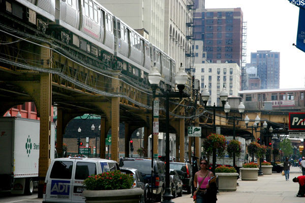 Rapid transit trains pass on elevated loop. Chicago, IL.