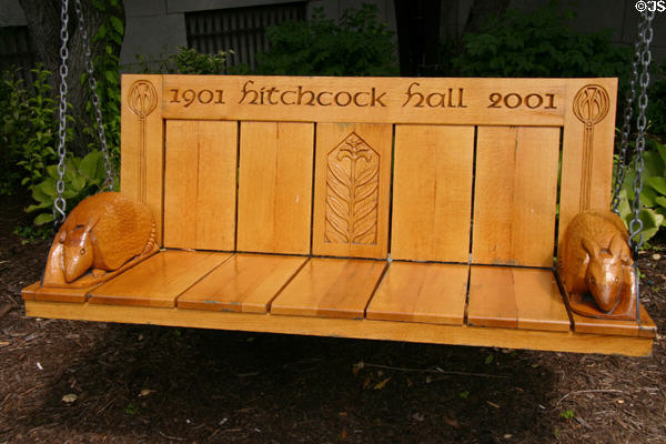 Commemorative swinging bench (2001) with 2 carved armadillo's as arm rests at University of Chicago. Chicago, IL.