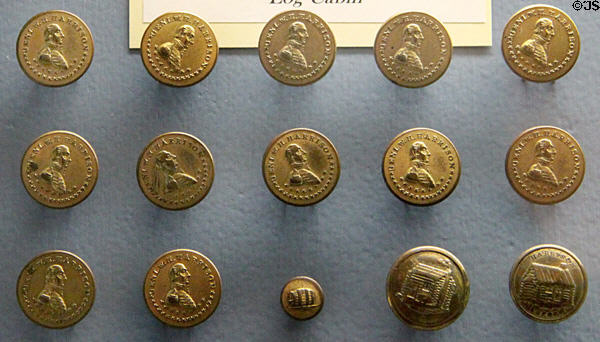 Log cabin, cider jug & William Henry Harrison campaign coins (1840-1) at Grouseland. Vincennes, IN.