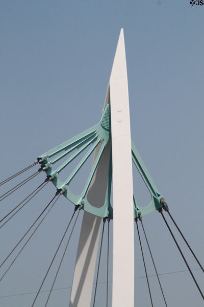 Pedestrian suspension bridge structure (2007) over Arkansas Rivers beyond Keeper of the Plains sculpture. Wichita, KS.