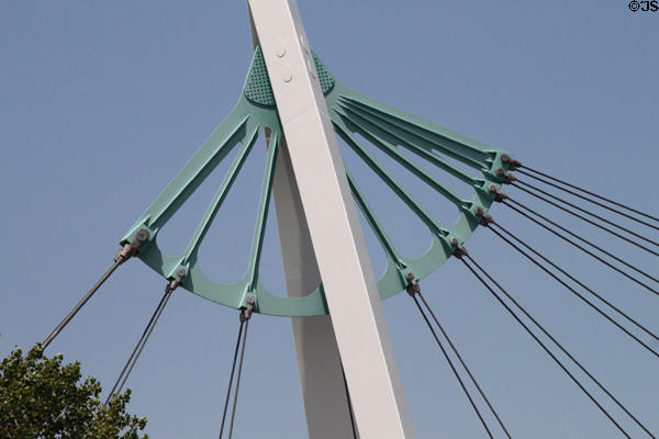 Pedestrian suspension bridge structure (2007) over Arkansas Rivers beyond Keeper of the Plains sculpture. Wichita, KS.