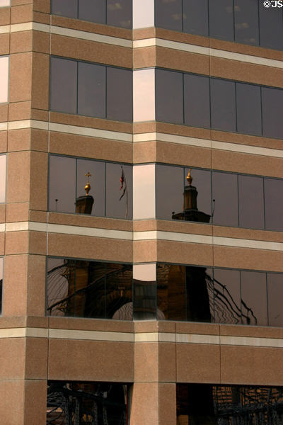 Roebling Suspension Bridge reflected in Covington highrise. Covington, KY.