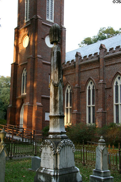 Draped tombstone & tower of Grace Episcopal Church. St. Francisville, LA.