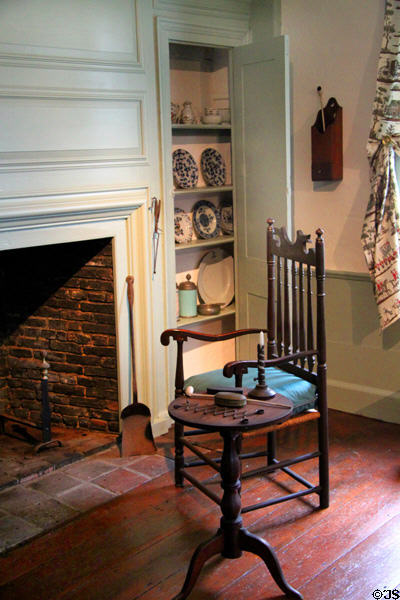 Chair beside parlor fireplace in Crowninshield-Bentley House of Peabody Essex Museum. Salem, MA.