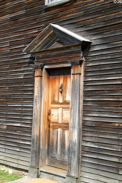 Colonial John Adams birthplace house where wood was unpainted because paint was more costly than replacing exterior boards. Quincy, MA.