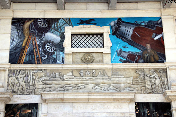 Contrast of civilian & war planes over mining, shipping & rubber plantations needed for car production on west wall of Detroit Industry Murals by Diego Rivera at Detroit Institute of Arts. Detroit, MI.