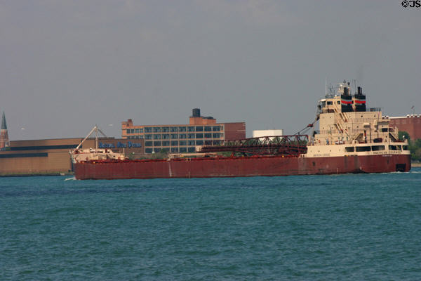 Great Lakes freighter American Courage passes Detroit Free Press building on Detroit River. MI.