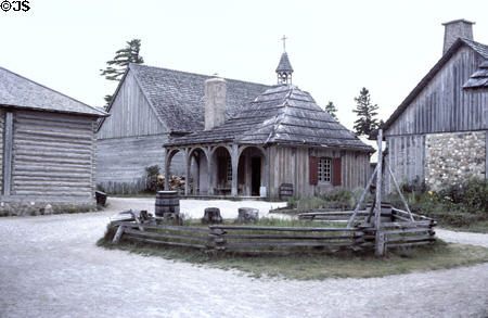 Guardhouse with arcade & spired St Anne church at Colonial Michilimackinac. Mackinaw City, MI.