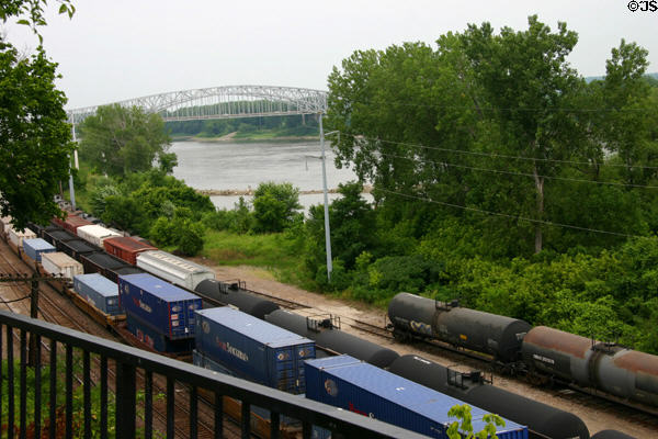 Freight train runs along Missouri River past U.S. 54 Bridge. Jefferson City, MO.
