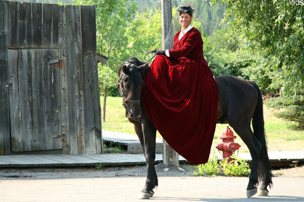 Young lady riding sidesaddle in long gown. Virginia City, MT.