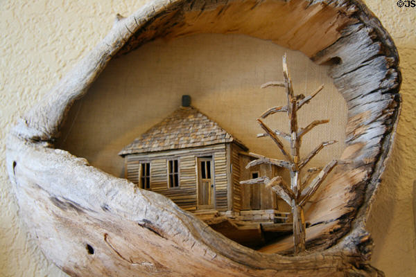 Sculpted cabin scene by H.H. Kenfield n Petrified Wood Gallery. Ogallala, NE.