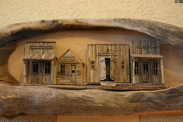 Sculpted frontier streetscape by H.H. Kenfield in Petrified Wood Gallery. Ogallala, NE.