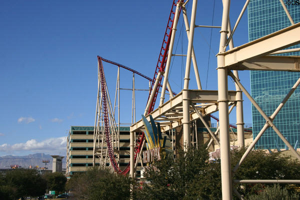 New York, New York Hotel roller coaster structure above hills of Las Vegas. Las Vegas, NV.