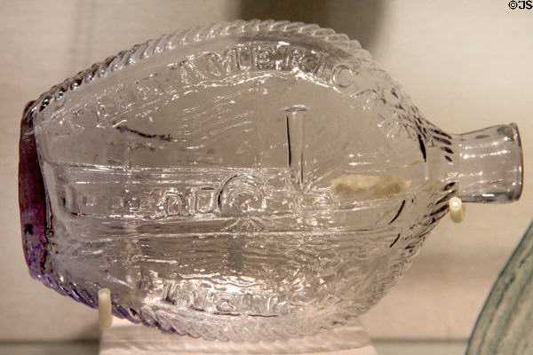Glass liquor flasks with steamboat & slogan "The American System" promotes tariffs to protect American manufactured goods as introduced Henry Clay in his run for president (1824) at Corning Museum of Glass. Corning, NY.