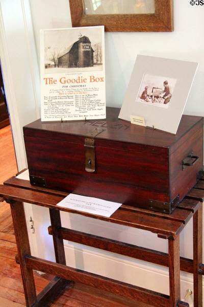 Roycroft Goodie Box made as gift hamper for Roycroft food items sits on Roycroft luggage rack from Roycroft Inn at Elbert Hubbard Roycroft Museum. East Aurora, NY.