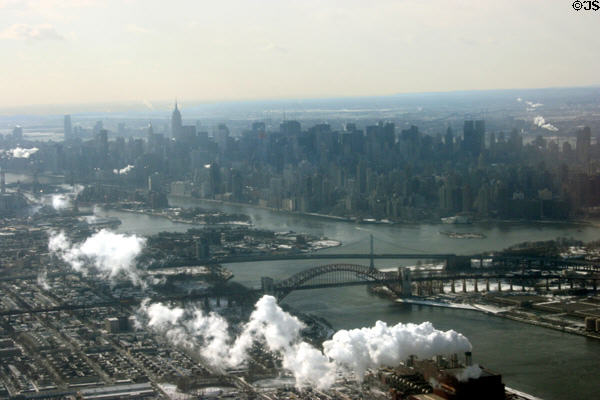 Manhattan skyline over Triborough Suspension (1936 by Othmar H. Ammann) & arched Hell's Gate (298m) railway (1916 by Gustav Lindenthal) bridges from air. New York, NY.