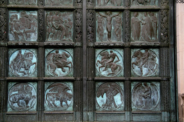 Bronze doors of St John the Divine with evangelistic symbols in bottom row. New York, NY.