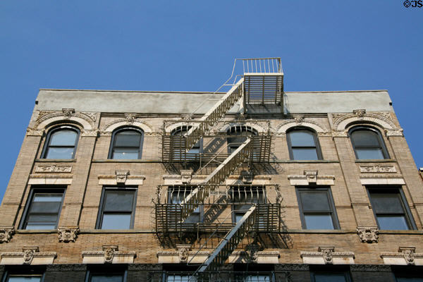 Heritage building with overhanging fire escape on Orchard St. New York, NY.