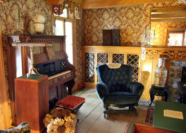 Parlor of Alice Austen House Museum with organ & stationary rocking chair. Staten Island, NY.
