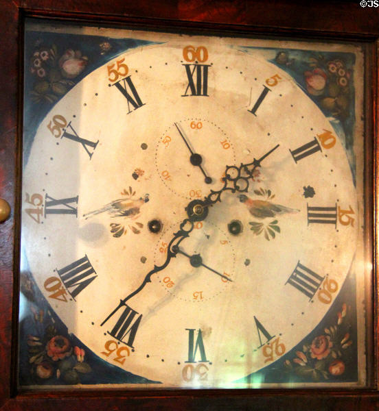 Face of tall clock with bird design & both Roman & Arabic numbers at Home Sweet Home Museum. East Hampton, NY.