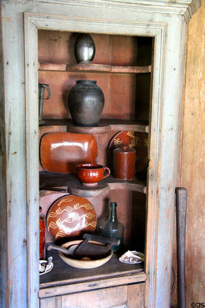 Built in cupboard with American redware pottery at Thomas Halsey Homestead. South Hampton, NY.