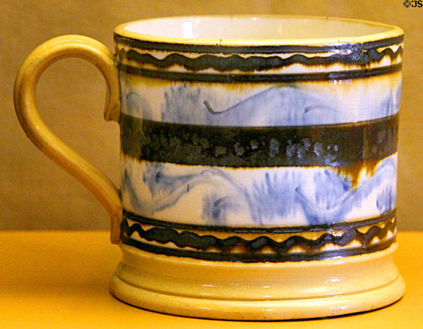 Yellow ware frog mug with blue seaweed decoration from East Liverpool at Museum of Ceramics. East Liverpool, OH.