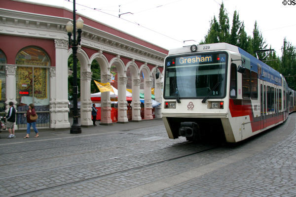 Streetcar passes Ankeny Square Colonnade. Portland, OR.