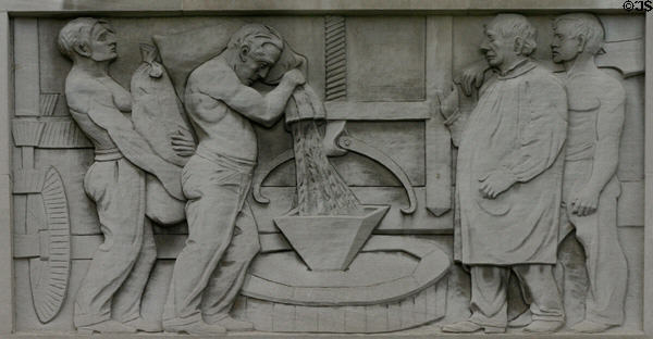 Relief of grinding grain using a millstone on Bank of America Building. Providence, RI.