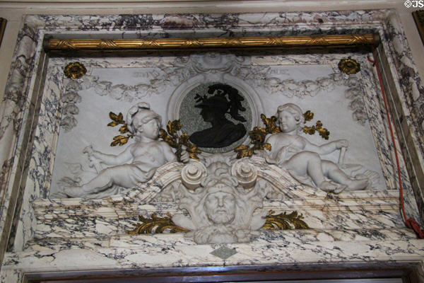 Neoclassical bronze relief of helmeted Athena over carved marble relief of Hercules & two cherubs in Gallery Hall at The Elms. Newport, RI.