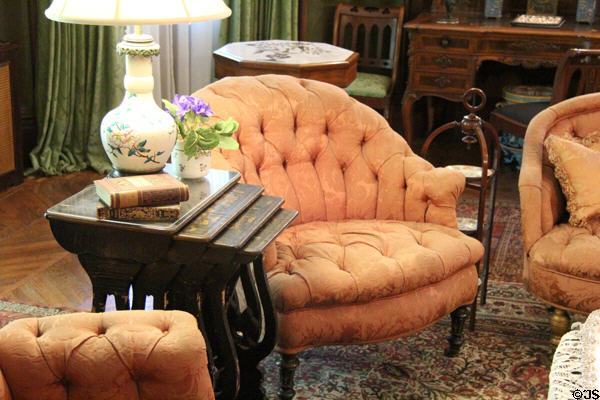 Stacking tables & stuffed chair in South Parlor/Sitting Room at Kingscote. Newport, RI.