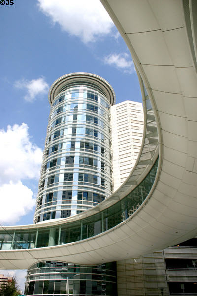Circular pedestrian bridge over Smith Street with circular mirrored building. Houston, TX.