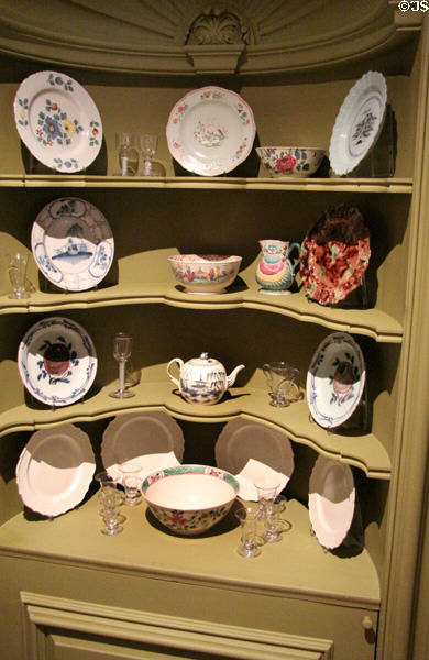 Corner cabinet with ceramic plates & bowls in Newport room at Bayou Bend. Houston, TX.