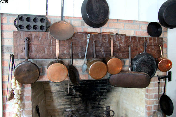 Copper & iron pots over kitchen fireplace at Nichols-Rice-Cherry House at Sam Houston Park. Houston, TX.