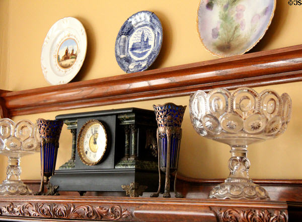 Mantle clock, glass footed bowls & commemorative plates in Staiti House at Sam Houston Park. Houston, TX.