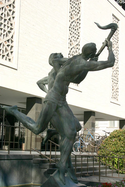 University of Texas Peter T. Flawn Academic Center with sculpture Torchbearers (1963) by Charles Umlauf shows teacher passing torch of knowledge to a student. Austin, TX.