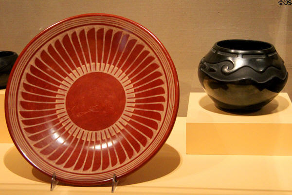 Red plate with feather decoration (c1965) by Maria Martinez & Popovi Da plus carved black jar (1940) by Antonio & Juanita Peña all of San Ildefonso at McNay Art Museum. San Antonio, TX.