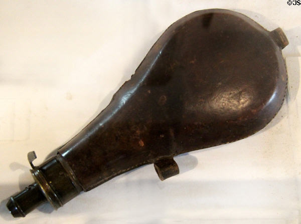 Leather over metal powder flask with measuring dispenser at Pioneer Museum. Fredericksburg, TX.