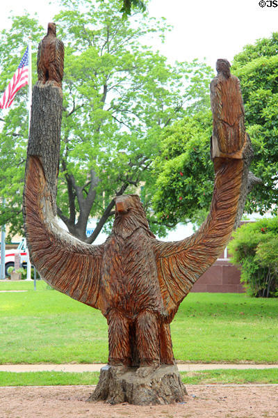 Tree stump carved into eagle with two young near Old Gillespie County Courthouse. Fredericksburg, TX.
