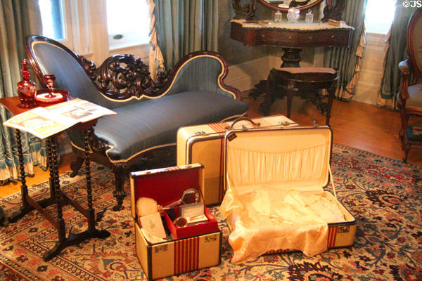 Settee with suitcases in bedroom at McFaddin-Ward House. Beaumont, TX.